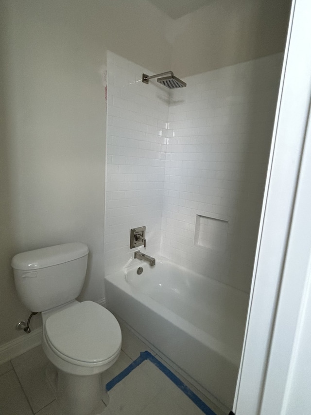 full bath featuring tile patterned flooring, toilet, washtub / shower combination, and baseboards