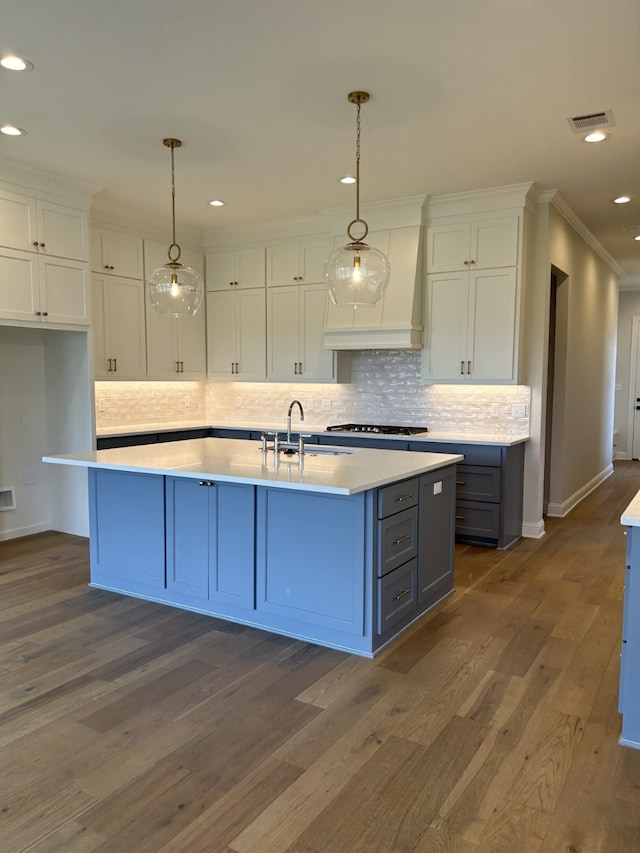 kitchen featuring visible vents, white cabinets, dark wood-style flooring, and light countertops