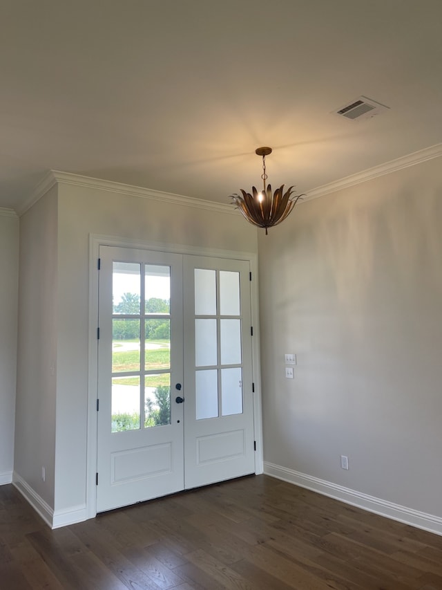 doorway with visible vents, dark wood finished floors, ornamental molding, french doors, and a chandelier