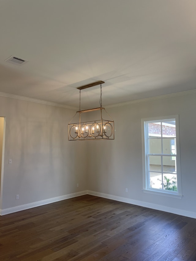 unfurnished dining area featuring dark wood finished floors, baseboards, visible vents, and ornamental molding