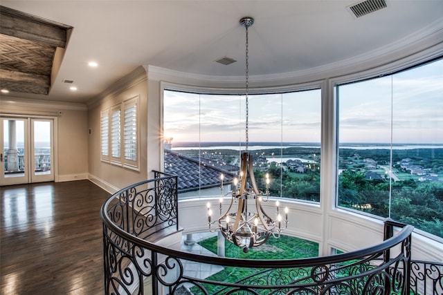 dining space featuring crown molding, an inviting chandelier, and dark hardwood / wood-style flooring