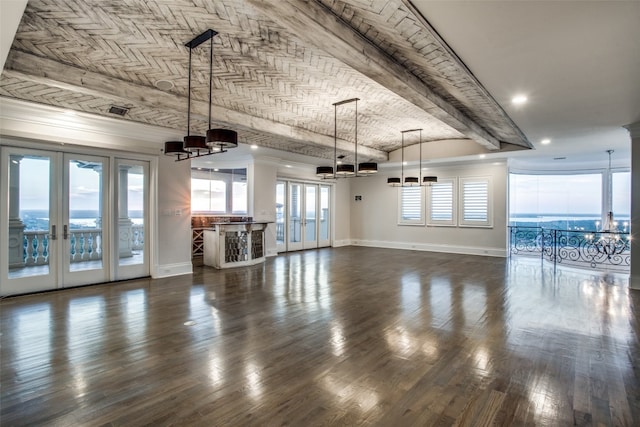 unfurnished living room featuring dark wood-type flooring, french doors, and an inviting chandelier