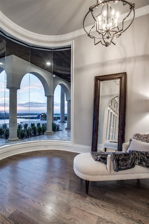 sitting room featuring a notable chandelier and dark hardwood / wood-style floors