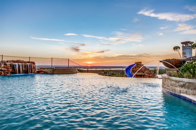 view of pool at dusk