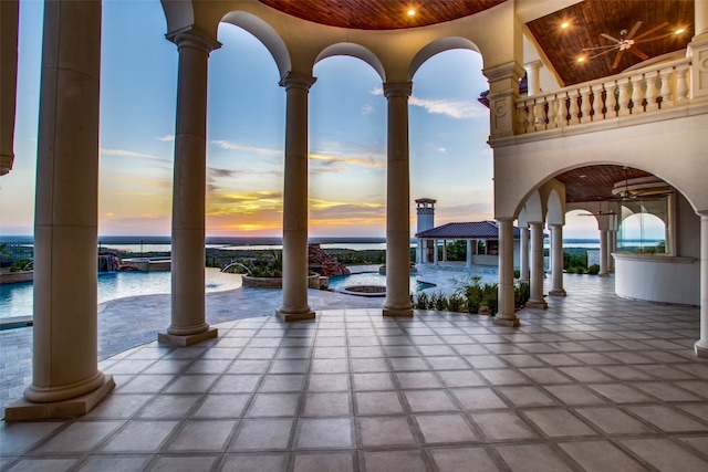 patio terrace at dusk featuring a gazebo, pool water feature, and a swimming pool with hot tub