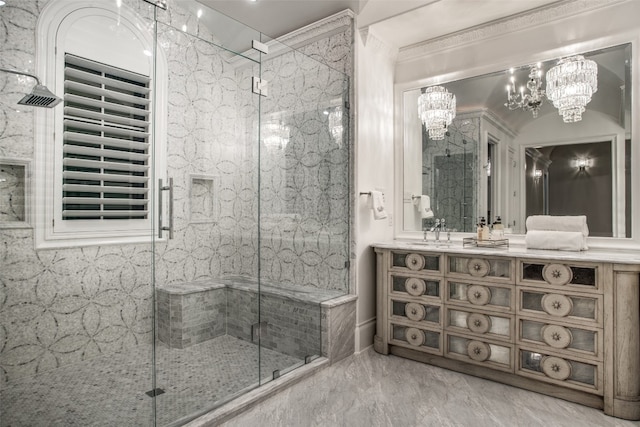 bathroom with tile flooring, a notable chandelier, a shower with door, and vanity