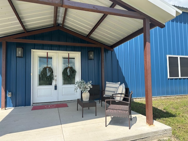 915 Ole Ambrose Rd, Bells, TX 75414 - entrance to property featuring french doors, a patio, and board and batten siding