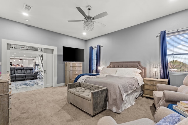 bedroom with light carpet and ceiling fan