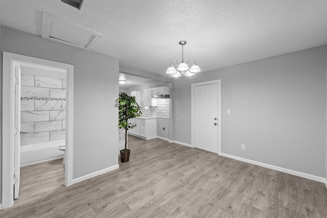 interior space featuring light hardwood / wood-style floors and a textured ceiling