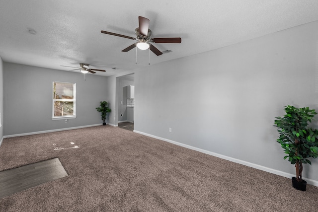 empty room featuring ceiling fan, carpet floors, and a textured ceiling