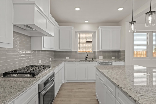 kitchen featuring backsplash, a wealth of natural light, and stainless steel appliances