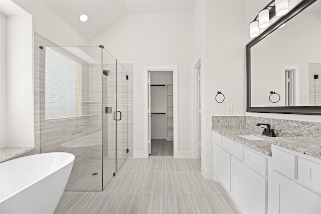 bathroom featuring tile floors, vanity, high vaulted ceiling, and plus walk in shower