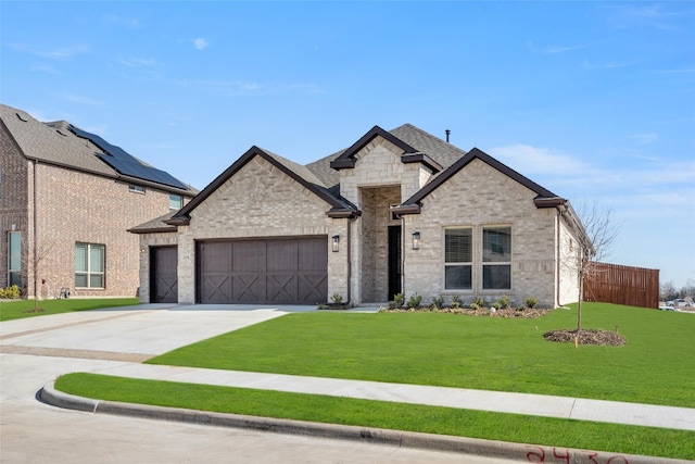 view of front of home featuring a front lawn, a garage, and solar panels