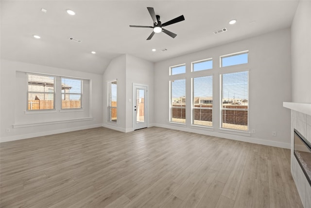 unfurnished living room with light hardwood / wood-style floors, ceiling fan, and a tile fireplace