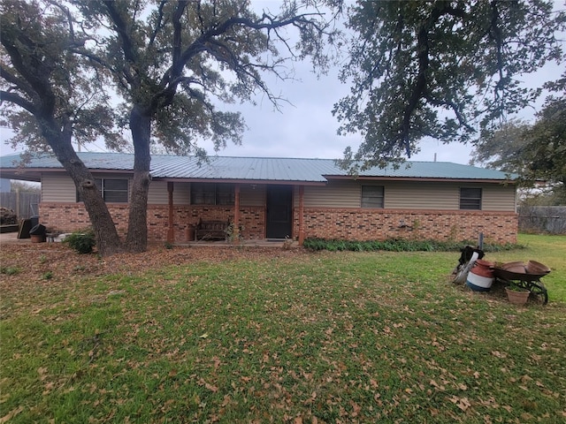 back of property featuring a yard and a patio