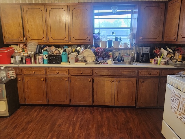 kitchen with dark hardwood / wood-style floors, white electric range oven, tasteful backsplash, and sink