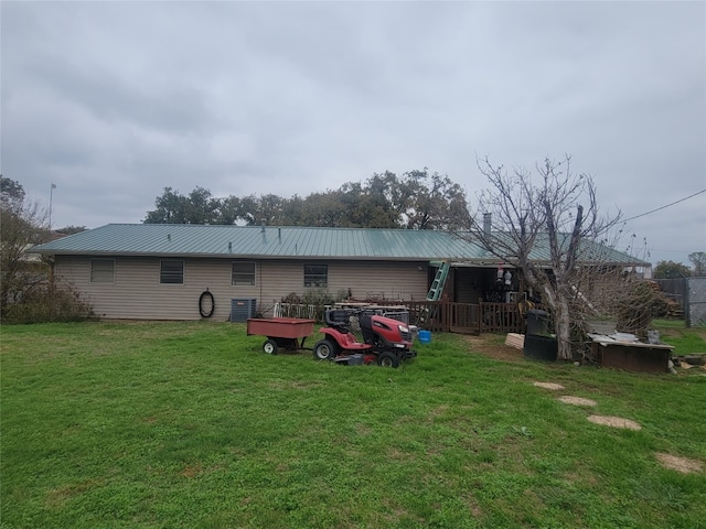 back of house with a lawn