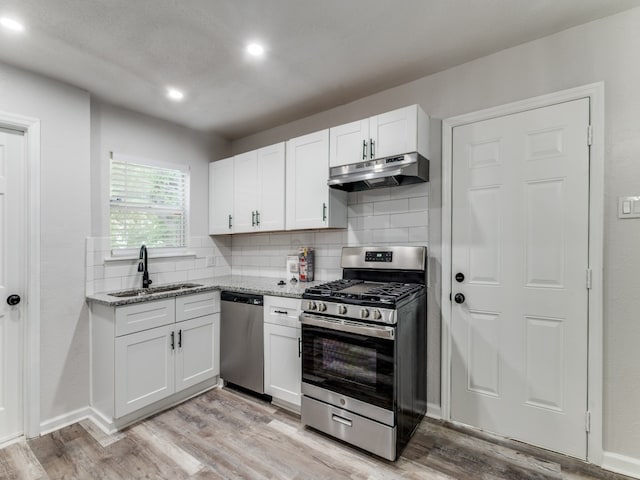 kitchen featuring white cabinets, stainless steel appliances, light hardwood / wood-style flooring, and sink