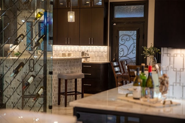 kitchen featuring dark brown cabinetry and tasteful backsplash