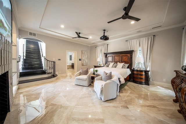 bedroom with ornamental molding, ceiling fan, and a tray ceiling