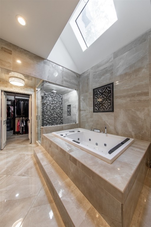 bathroom with lofted ceiling with skylight, independent shower and bath, and tile walls