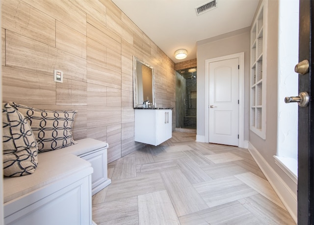 bathroom with tile walls and vanity