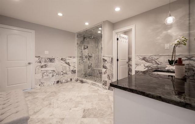 bathroom featuring walk in shower and tile walls