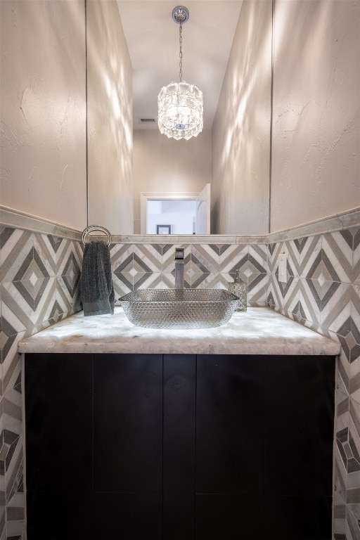 bathroom featuring tasteful backsplash and vanity