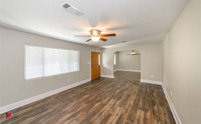 empty room with dark hardwood / wood-style floors and ceiling fan