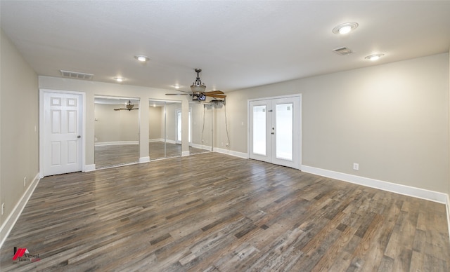 empty room with french doors, dark hardwood / wood-style floors, and ceiling fan