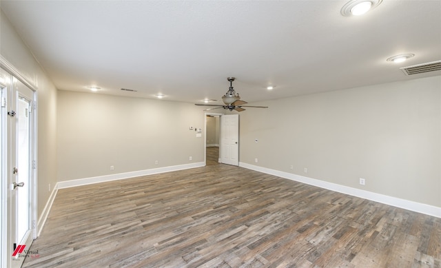 spare room featuring ceiling fan and dark wood-type flooring