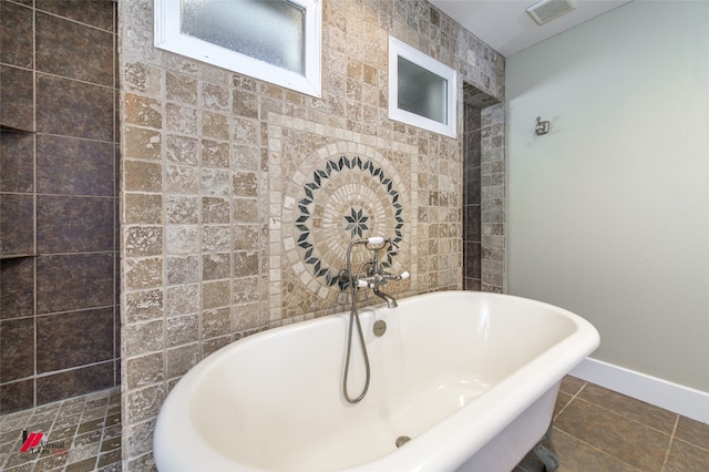 bathroom with a tub, tile flooring, and tile walls