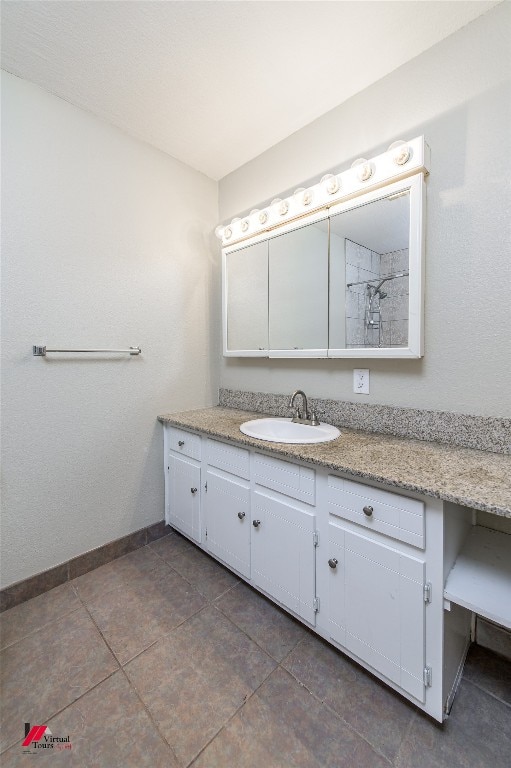 bathroom with vanity and tile flooring