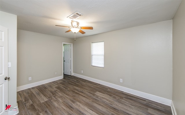 spare room with dark hardwood / wood-style flooring and ceiling fan