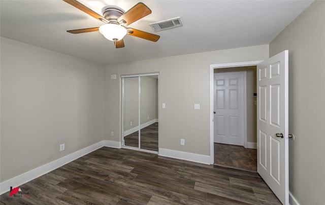 unfurnished bedroom with a closet, ceiling fan, and dark wood-type flooring