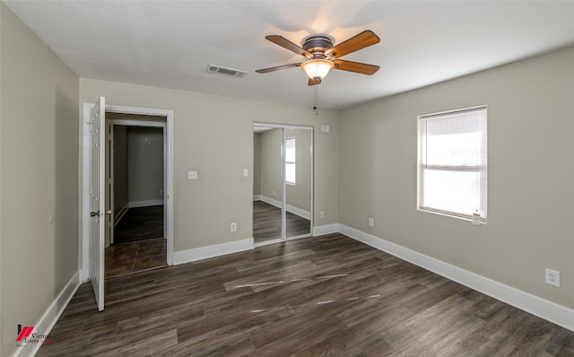 interior space featuring ceiling fan and dark wood-type flooring