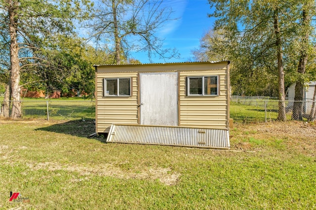 view of shed / structure featuring a yard