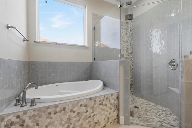 bathroom with shower with separate bathtub, tile floors, and a healthy amount of sunlight