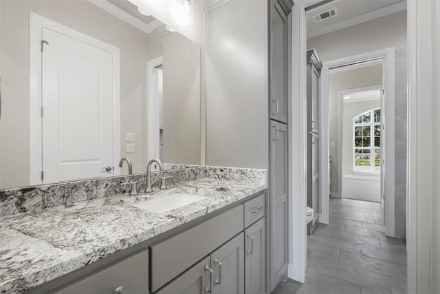 bathroom featuring tile floors, large vanity, and ornamental molding