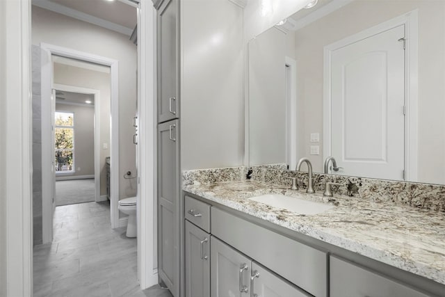 bathroom with tile floors, toilet, and vanity