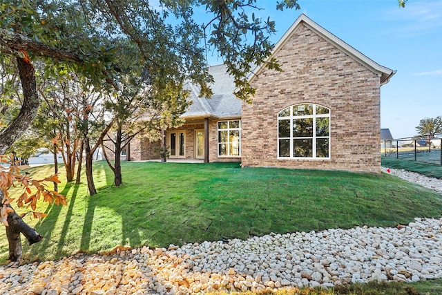 back of house featuring a yard