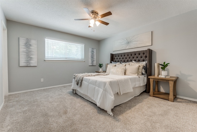 bedroom with light colored carpet, a textured ceiling, and ceiling fan