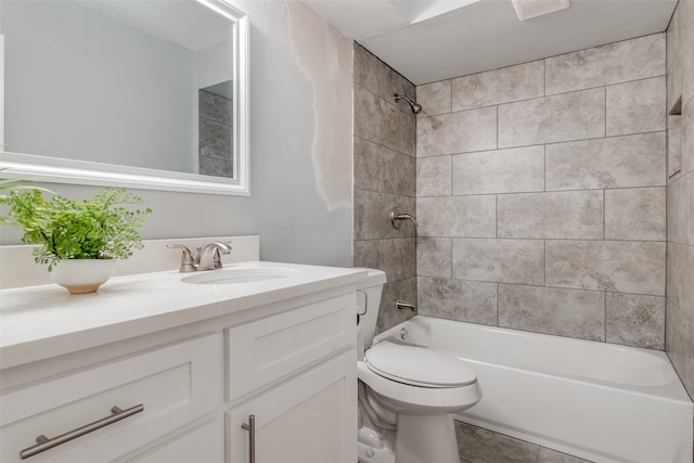 full bathroom with tile patterned flooring, toilet, vanity, and tiled shower / bath