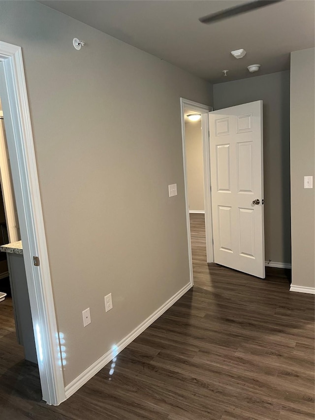 interior space with baseboards and dark wood finished floors