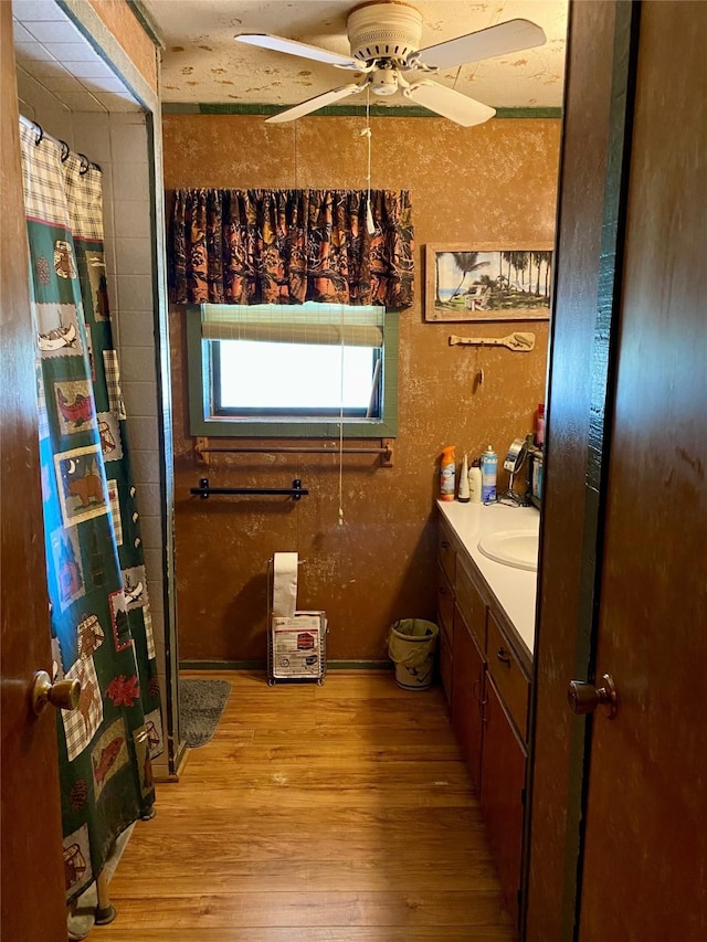 bathroom featuring hardwood / wood-style floors, vanity, and ceiling fan