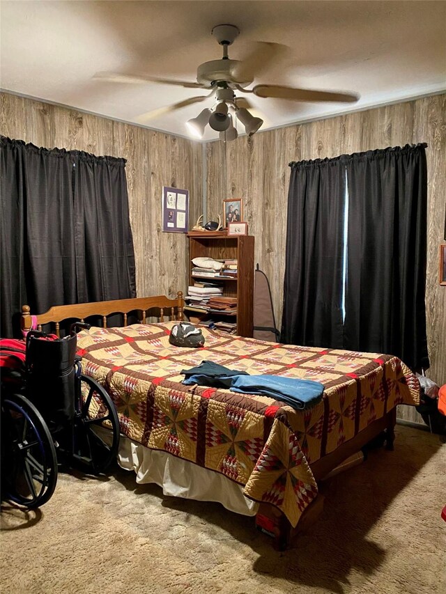 bedroom featuring carpet flooring, ceiling fan, and wooden walls