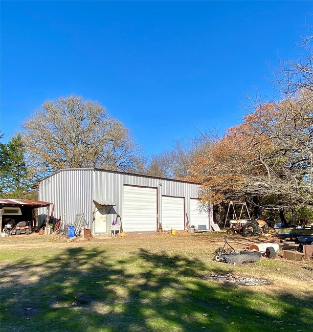 view of outbuilding with a lawn and a garage