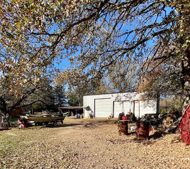 view of yard featuring a garage and an outdoor structure