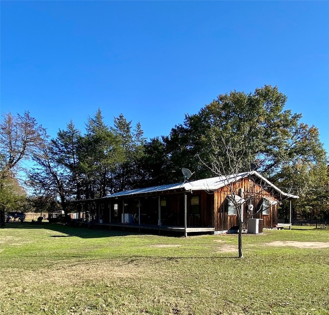 view of front facade with central AC and a front lawn