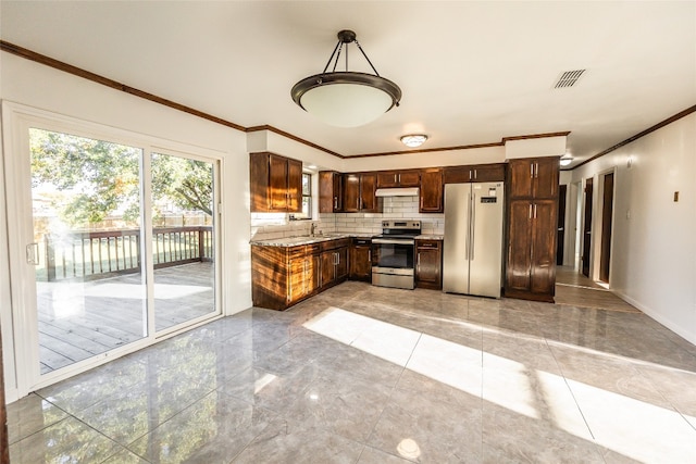 kitchen with sink, stainless steel appliances, tile flooring, tasteful backsplash, and decorative light fixtures